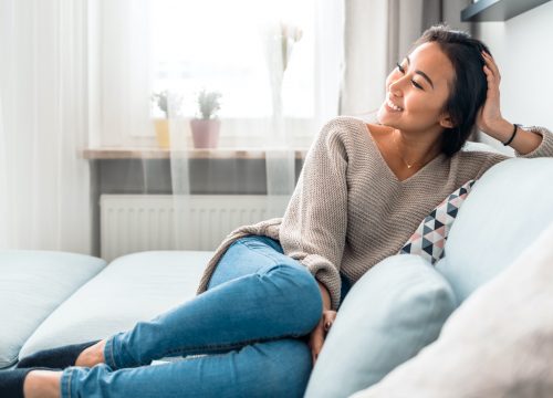 Woman with abnormal pap smears sitting on the couch