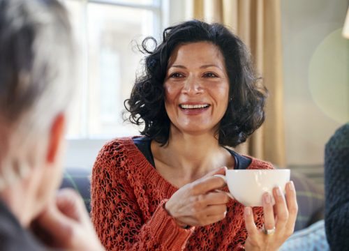 Older woman with fibroids sipping tea with friends